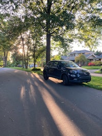 a black car parked on a residential street