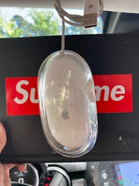 a supreme mouse in the back of a car