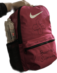 a red backpack with writing on it that says nike booting supreme