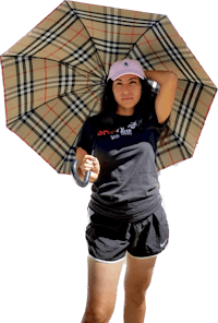 a woman holding an umbrella in front of a black background