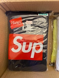 a box of supreme t - shirts in a box